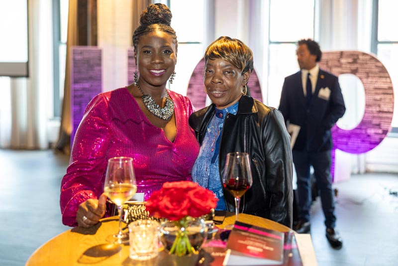 Two women standing at table