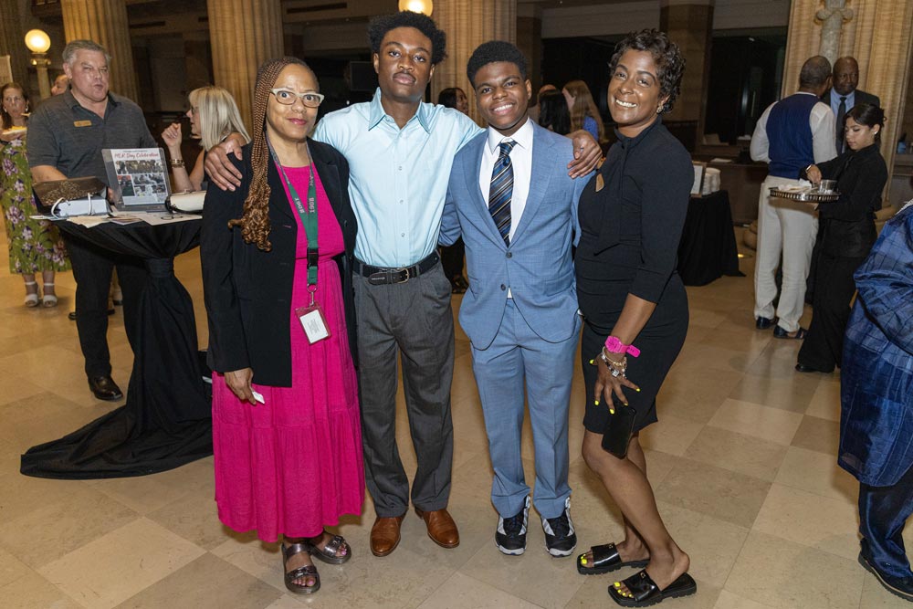 Four people gathered near a table at the gala