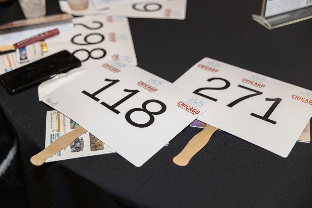 paddles with bid numbers on table